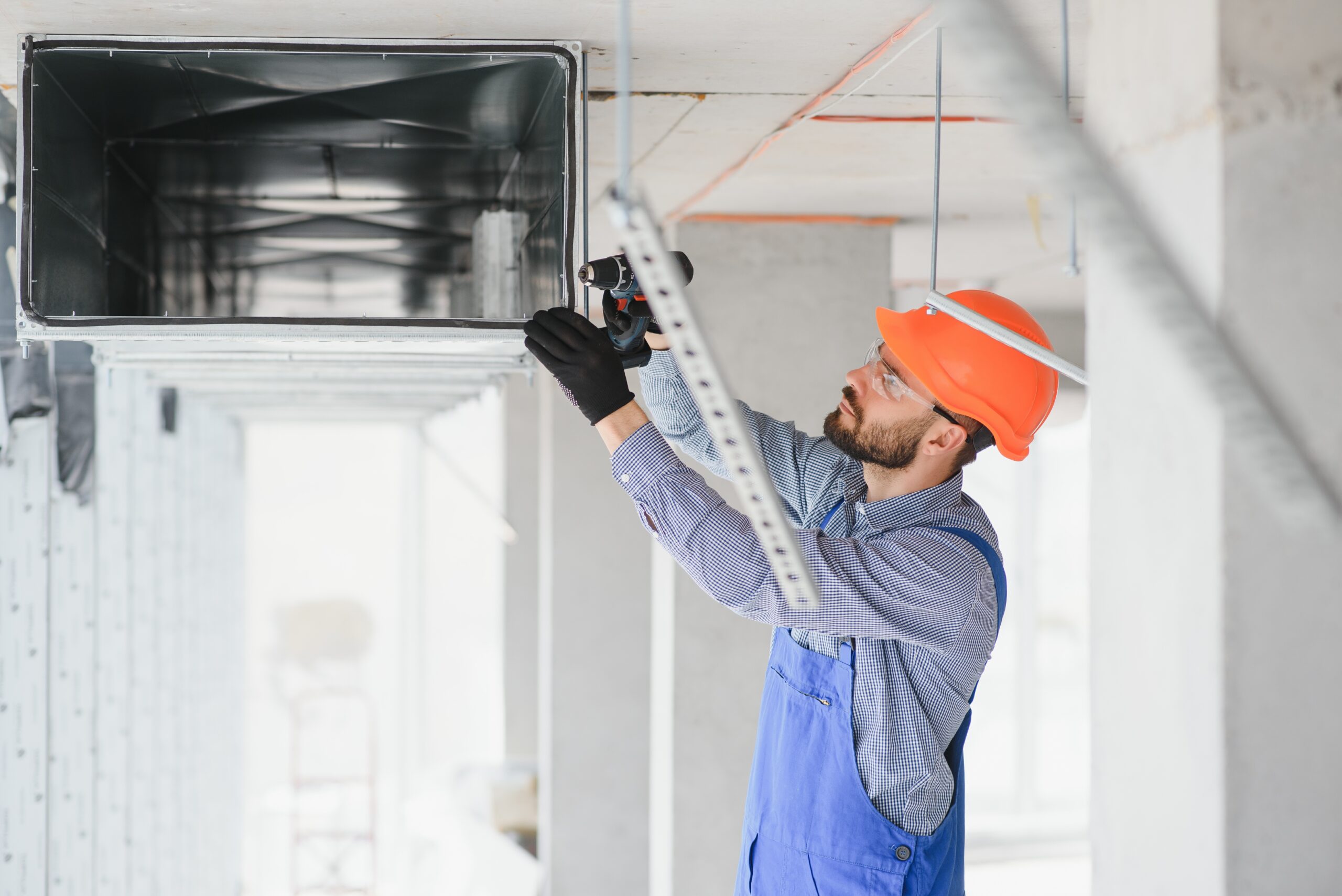 hvac engineer install heat recovery ventilation system for new house. copy space