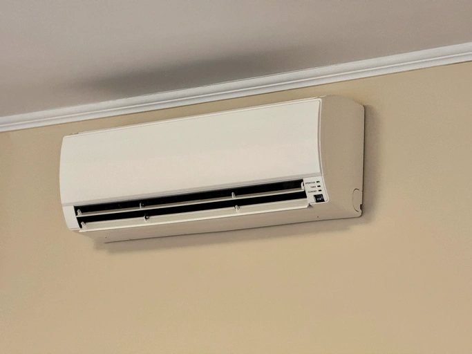 White air conditioner mounted on a wall.